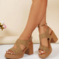 Women's tan suede-finish platform sandals featuring an open toe, a V-cut forefoot strap, and a ribbed block heel, worn with an ankle bracelet. These elegant one-strap sandals showcase a secure hook-and-loop closure for comfortable, chic wear.