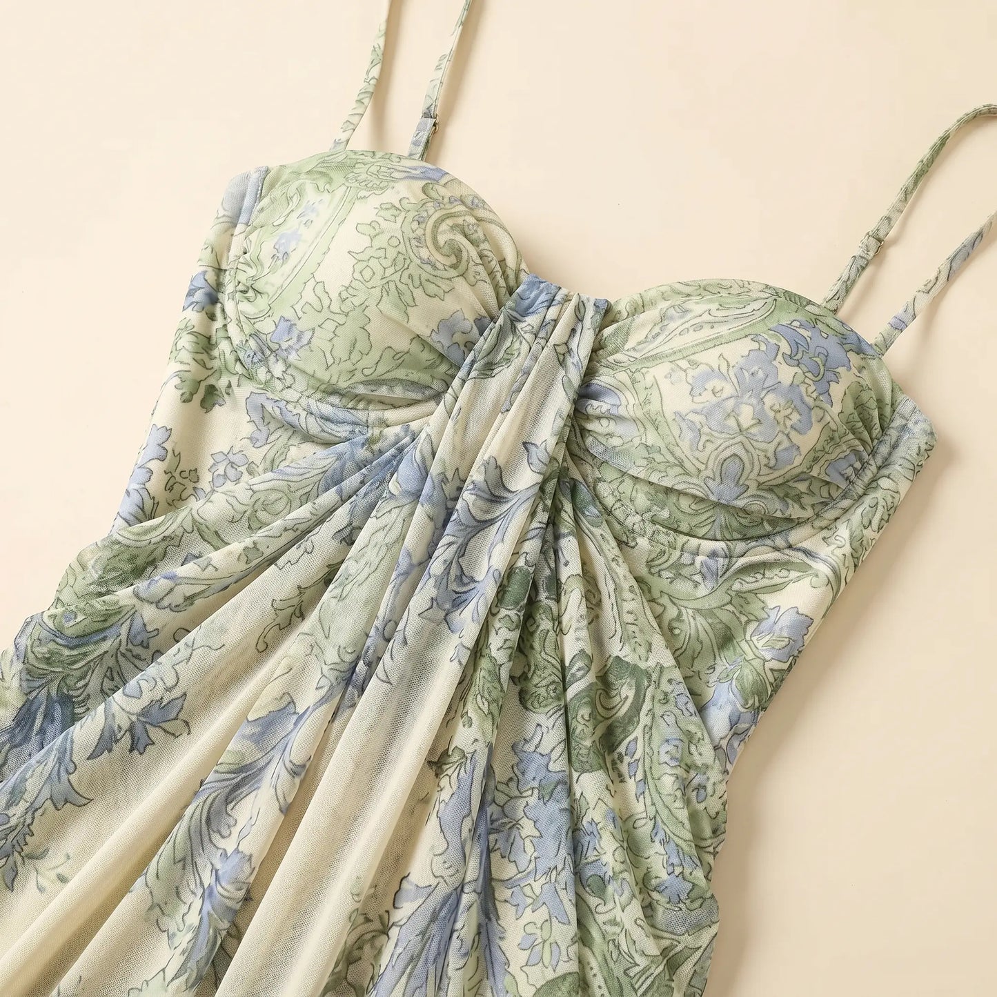 Close-up of a Zenthos green and blue botanical floral mesh maxi dress, showcasing the gathered sweetheart bodice, spaghetti straps, and ruched fabric.