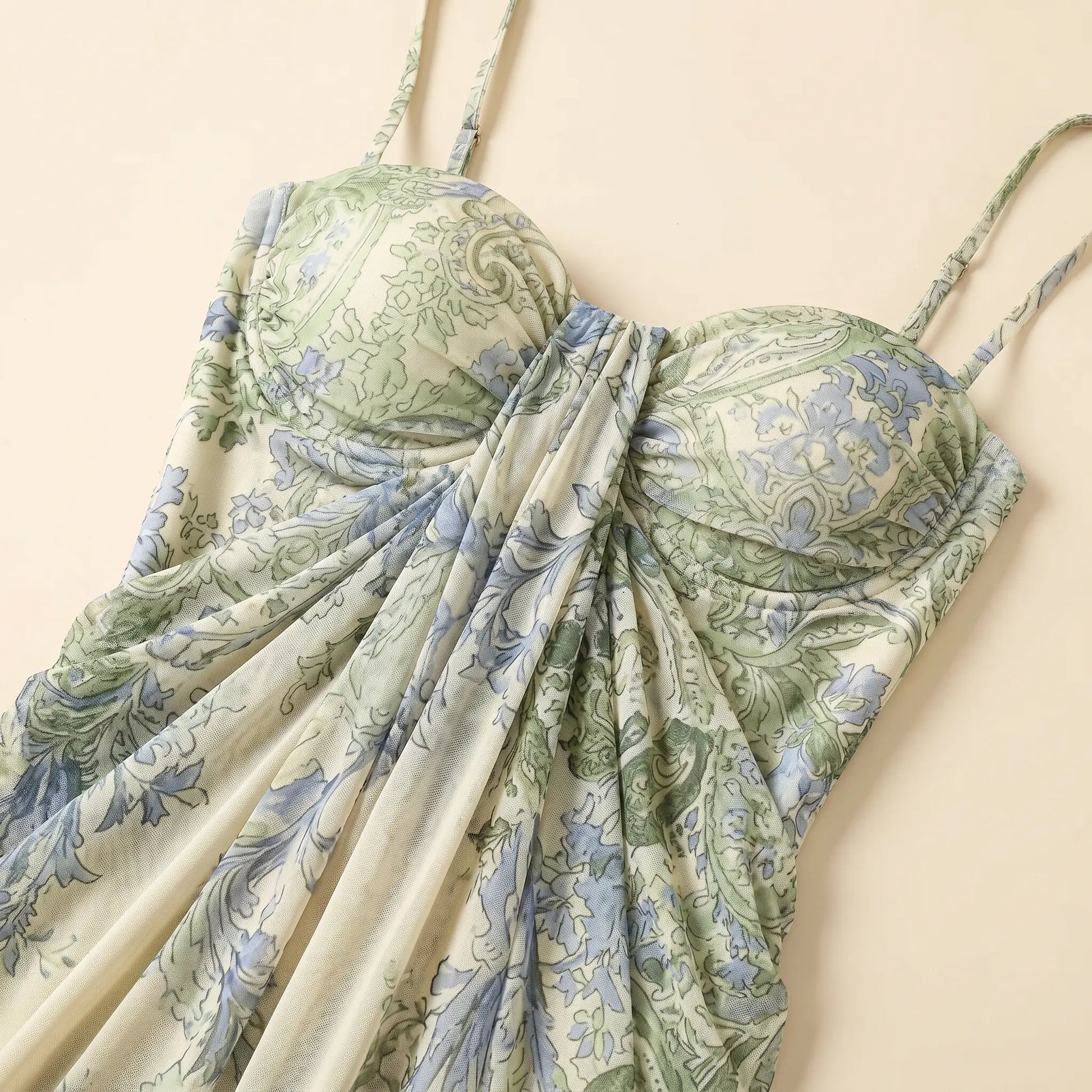 Close-up of a Zenthos green and blue botanical floral mesh maxi dress, showcasing the gathered sweetheart bodice, spaghetti straps, and ruched fabric.