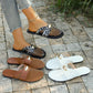 Women's breathable mesh pointed-toe flat mules with gold oval hardware and faux leather trim, shown worn by a model and laid out in brown and white variants on a paved surface.