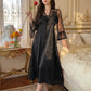 Sylven Midnight Black satin nightgown, floral lace V-neck, sheer polka dot bell sleeves, worn by model in romantic bedroom.