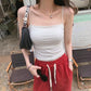 Model wearing a Pure White Miroka ruched camisole top, featuring ultra-thin spaghetti straps, a straight neckline, and built-in padding, styled in an outdoor setting.