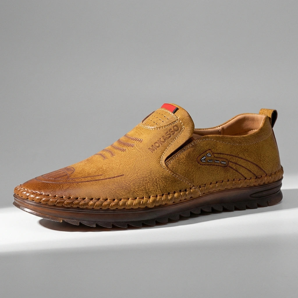 Mokasso men's comfort driving loafer in saddle brown vegan leather, side profile view showing hand-stitched details and embossed logo.