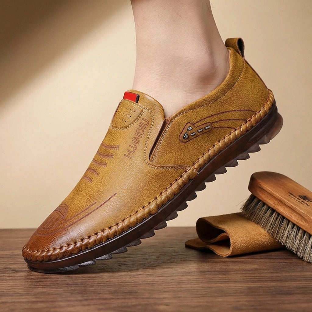 Mokasso men's comfort driving loafer in brown vegan leather, side view showing hand-stitched details and flexible sole profile.