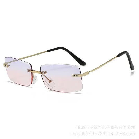 Rimless square-ish sunglasses with gradient pink-to-blue lenses, gold-tone metal bridge, and black acetate temple tips. Features adjustable silicone nose pads for comfort.