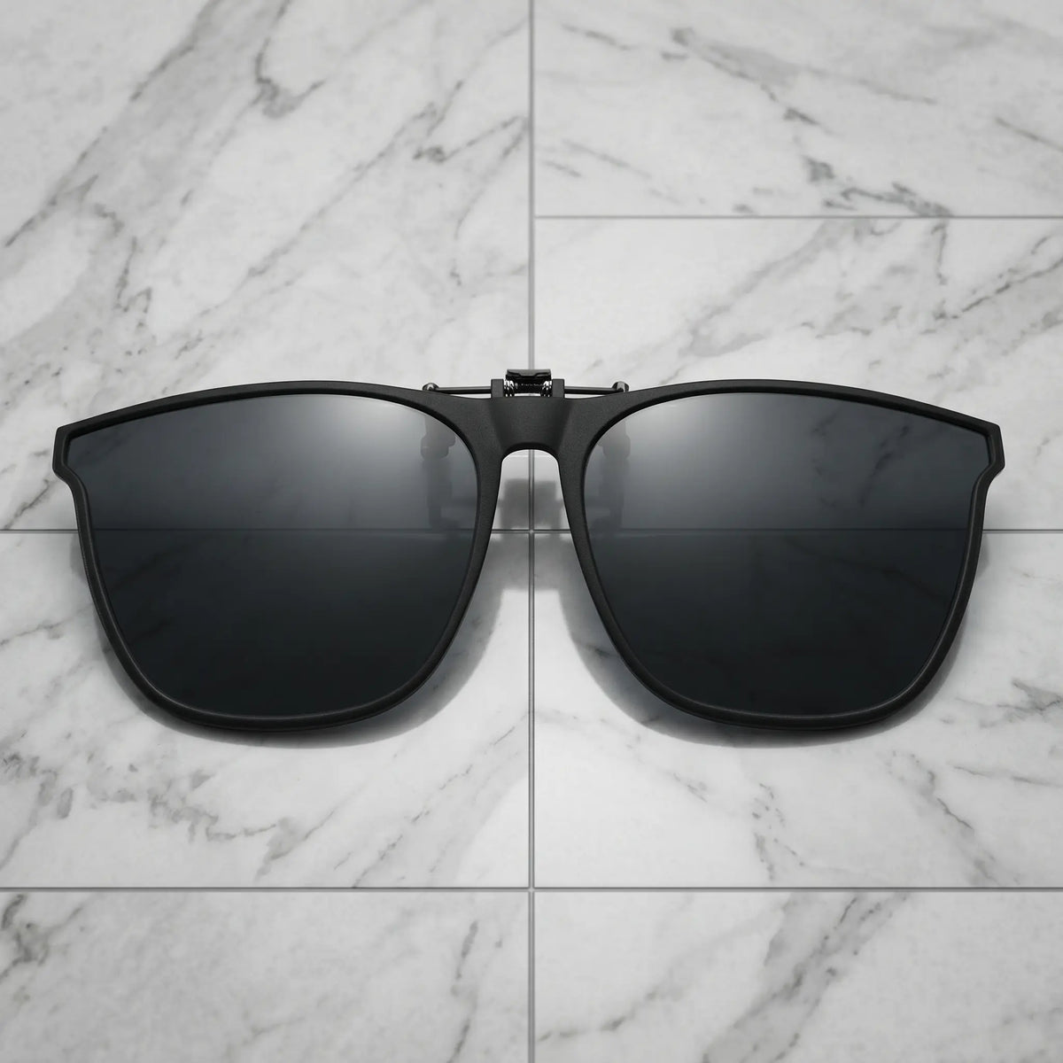 Nalani matte black metal square clip-on sunglasses with dark polarized lenses, front view on a clean white background.