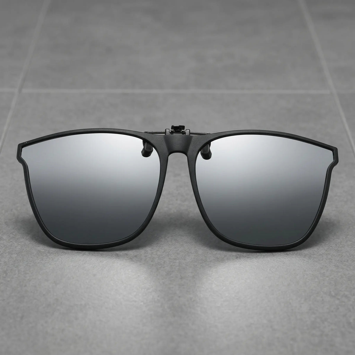 Matte black metal square clip-on sunglasses with grey polarized lenses, shown front-on against a clean white studio background.