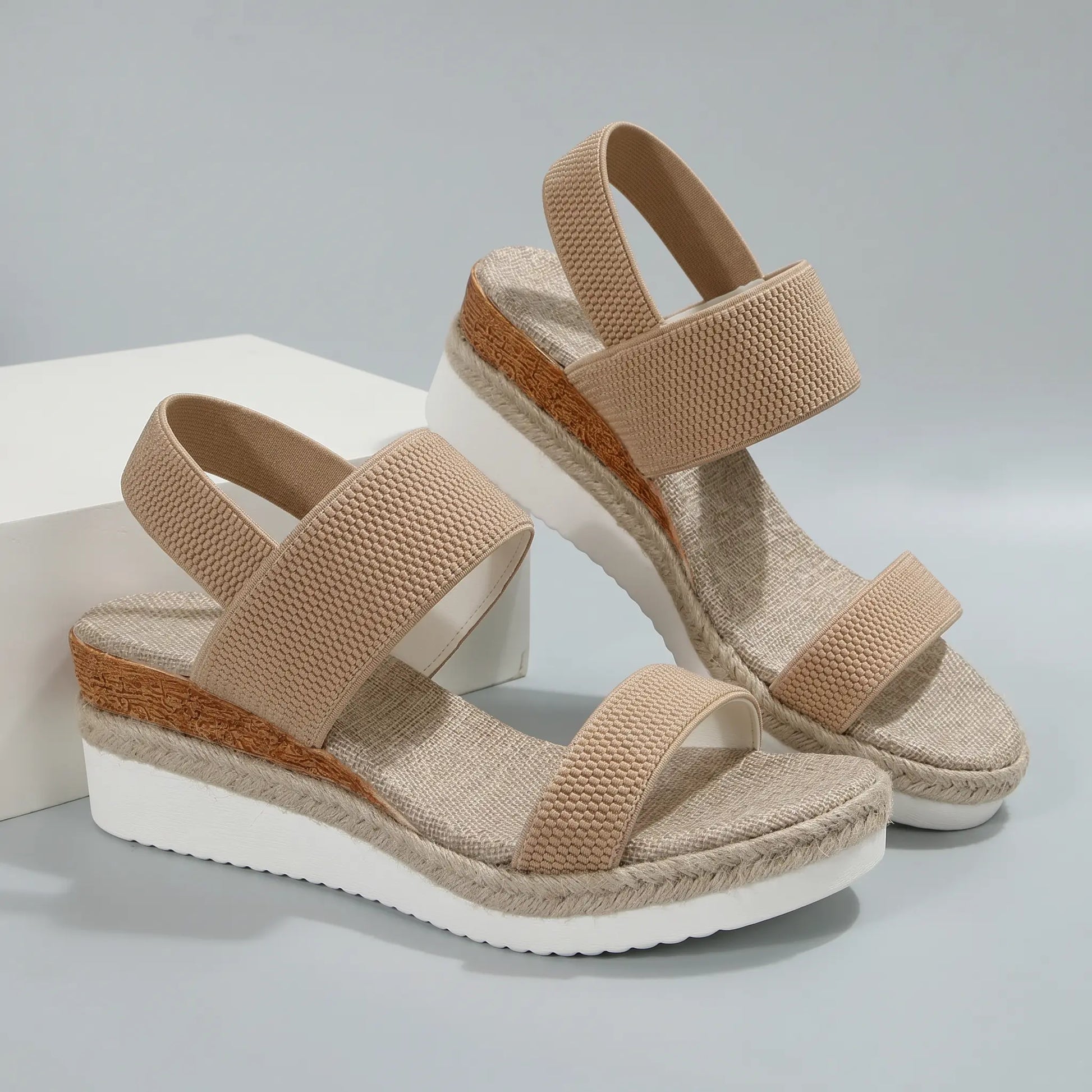 Natural khaki espadrille wedge sandals with textured mesh upper, peep toe, parallel elastic straps, and a woven jute platform sole.