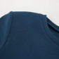 Close-up of a fitted navy ribbed knit dress, showcasing the crew neckline, shoulder detail, and fine vertical ribbing texture.