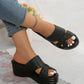 Nexaera black woven PU platform wedge sandals with peep-toe design, worn by a model with jeans and white-painted toenails, displayed on a textured studio background.