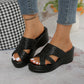 Nexaera black woven platform wedge slide sandals with peep-toe design and comfortable contoured footbed, worn by a model with cropped denim jeans.