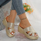 Nexaera metallic gold platform wedge sandals with a woven texture and peep-toe design, shown on a model wearing cropped denim jeans.
