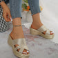 Shimmering gold platform wedge sandals worn by a model, featuring a woven texture, peep-toe design, and a high wedge heel. The footwear is styled with blue denim jeans and an anklet.