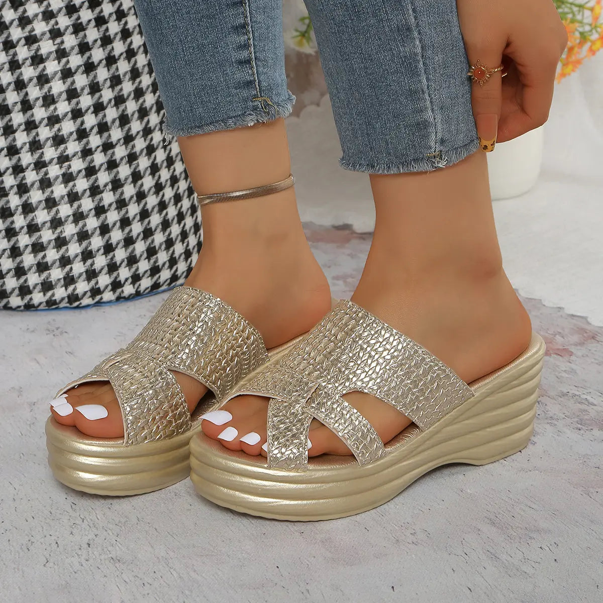 Nexaera metallic gold platform wedge sandals shown on a model's feet, featuring a woven PU upper and a peep-toe design.