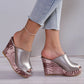 Nuvira metallic silver peep-toe wedge sandals with a textured rose gold patterned wedge heel, worn by a model with light blue jeans and a delicate anklet.