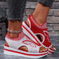 Women's red and white knitted wedge sandals with a white butterfly embroidery and a slingback strap, styled with grey jeans.