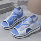 A pair of blue and white Nylira women's wedge sandals featuring a knitted butterfly design, peep-toe, and slingback strap. The layered wedge sole provides comfortable height.