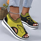 A pair of women's Nylira peep-toe wedge sandals in yellow and black, featuring a knitted butterfly design and a comfortable slingback strap. The sandals are worn with light-wash jeans, showcasing a stylish summer footwear option.