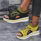 Nylira women's peep-toe wedge sandals in sunny yellow, featuring intricate black butterfly embroidery, a striped elastic collar, and a layered foam sole with a slingback strap. White-tipped toes are visible.