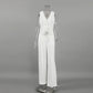 Nyxos white sleeveless V-neck vest and matching wide-leg trousers suit ensemble displayed on a mannequin.