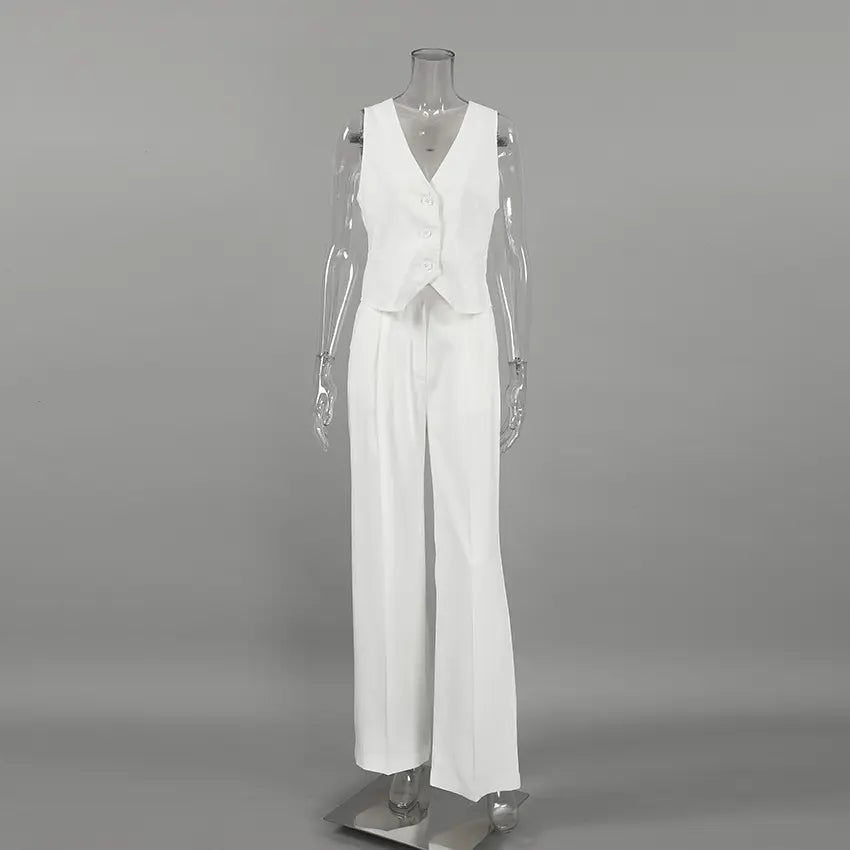 Nyxos white sleeveless V-neck vest and matching wide-leg trousers suit ensemble displayed on a mannequin.