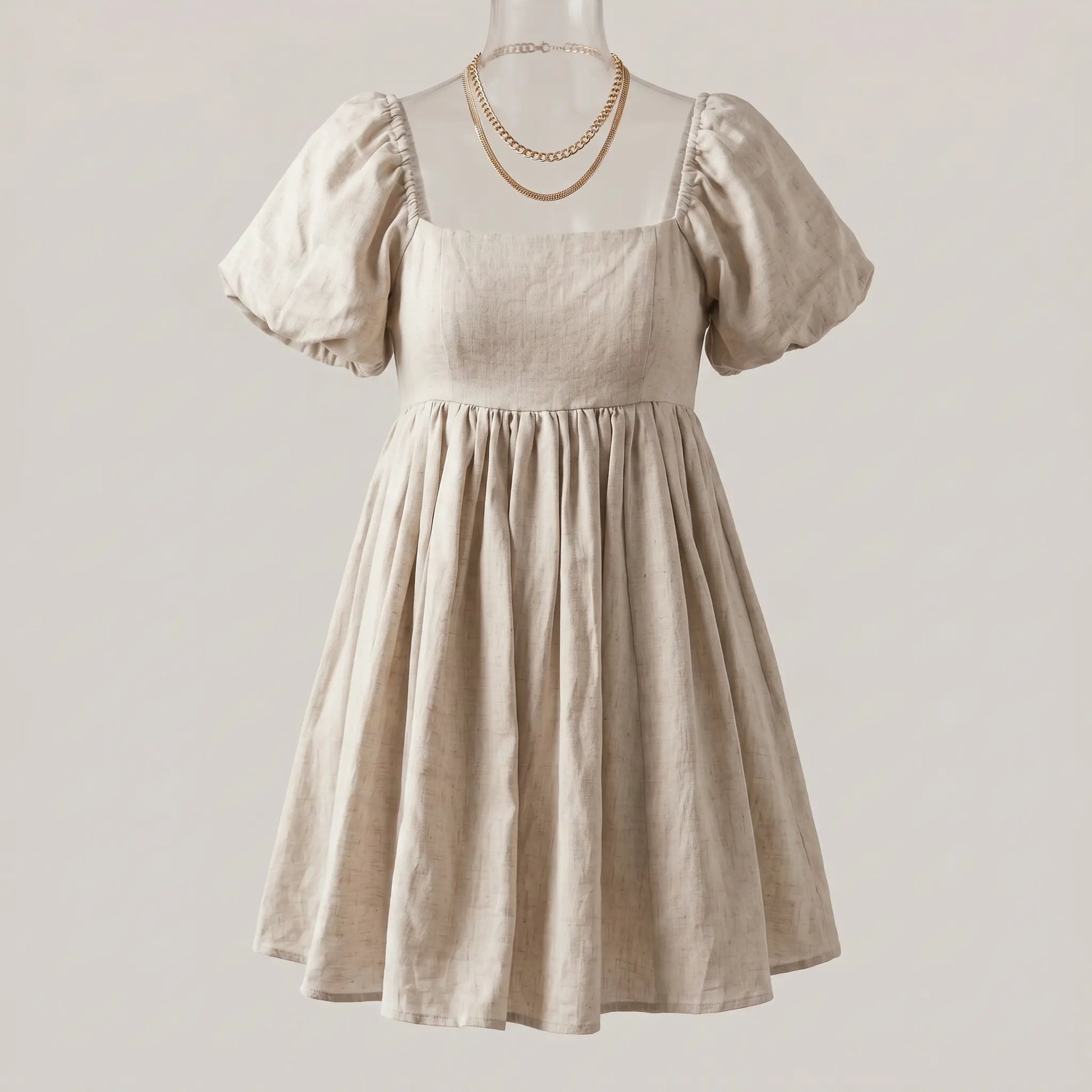 Ethereal Khaki linen blend short dress with a square neckline, voluminous puff sleeves, gathered waist, and flared mini skirt, displayed flat.