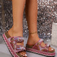 Rose pink platform slide sandals embellished with beads and sequins, featuring double adjustable buckle straps and a layered cork-effect sole, worn on feet with a shimmering background.