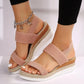Pink espadrille wedge sandals featuring textured mesh, a peep-toe, elasticated straps, a jute-wrapped platform sole, and a decorative ankle chain with charms.