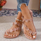 Pink bohemian flat thong sandals adorned with delicate floral appliques and clear rhinestones, shown worn with denim jeans on a textured rug.
