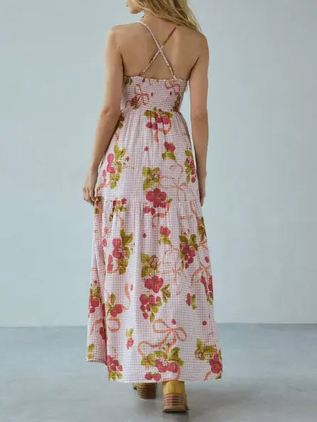 Back view of a Bohemian Floral Maxi Dress in pink gingham, featuring a smocked bodice, halter neckline with cross-back straps, and a flowing tiered skirt.