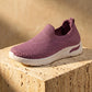 Plum purple knit slip-on sneaker, viewed from a three-quarter angle, showcasing its breathable perforated toe box and thick white sculpted sole with a subtle purple accent.