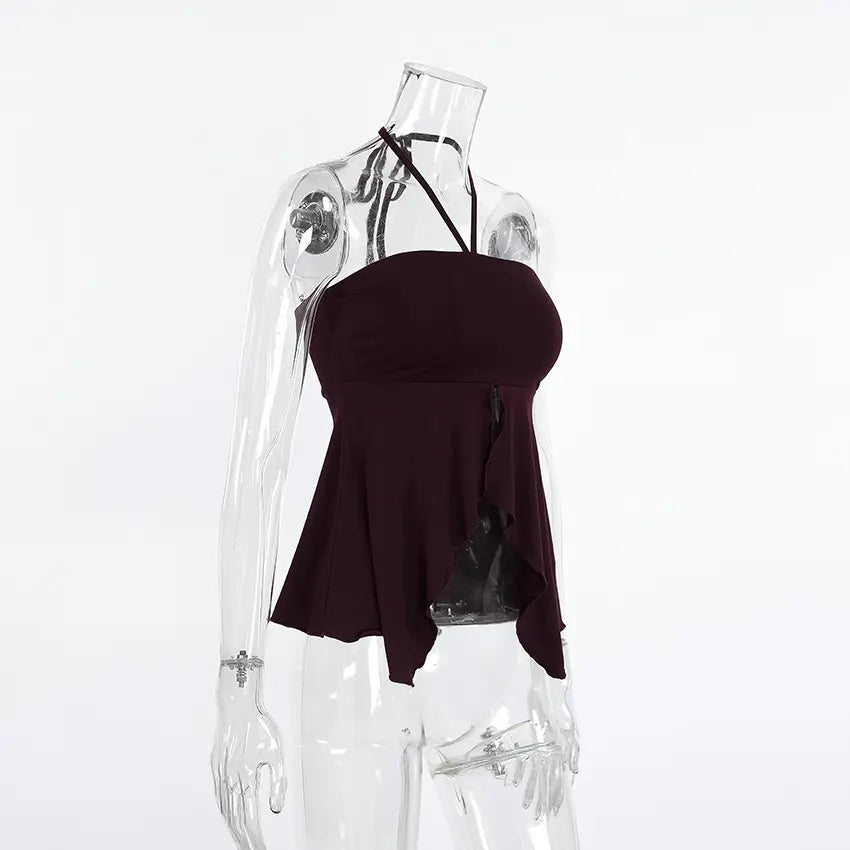 Deep plum ribbed halter crop top with a high front slit and asymmetric hem, shown from a three-quarter angle on a mannequin.