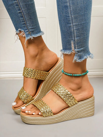 Women's Quorin gold woven metallic strap platform wedge sandals worn with distressed denim jeans, showcasing the open-toe slip-on style and champagne gold wedge heel.