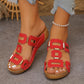 Fiery red Kyorin platform wedge sandals with geometric gold embellishments and a T-strap design, worn by a model with a pearl anklet.