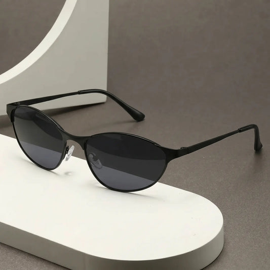Rhodan retro-futuristic angular cat-eye sunglasses in black metal with dark grey lenses and black acetate temple tips.