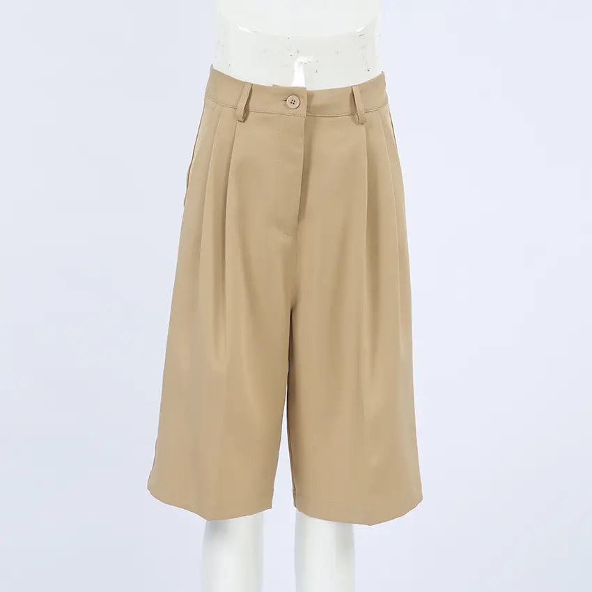 Rhyza women's high-waisted, wide-leg Bermuda shorts in warm khaki, shown front view. Features tailored pleats, a smooth waistband with button closure, and a finished cuffed hem.