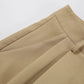 Close-up view of high-waisted Rhyza Tailored Bermuda Shorts in Khaki, showcasing the smooth polyester blend fabric, crisp front pleats, and a visible belt loop.
