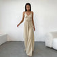 Rhyzen high-waisted wide-leg trousers in textured oat-beige breathable cotton, worn by a model with deep side slits and a drawstring waist. Shot from the front in a studio.