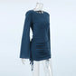 Deep teal ribbed knit mini dress with dramatic flared bell sleeves, side ruching with drawstring ties, and a crew neckline, shown from a three-quarter angle.