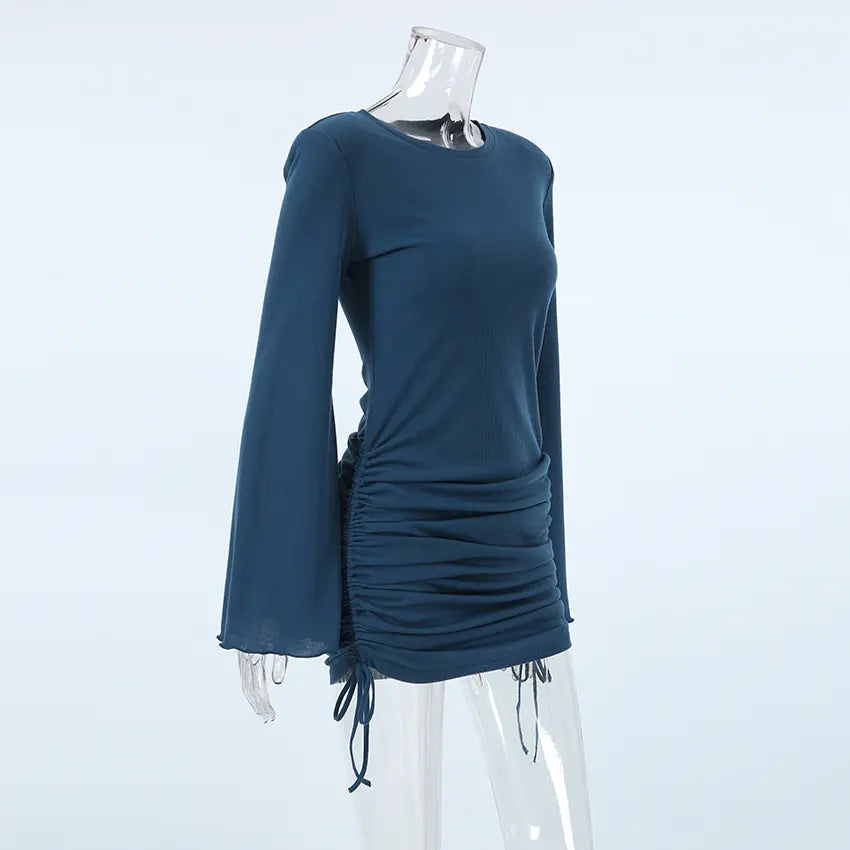 Deep teal ribbed knit mini dress with dramatic flared bell sleeves, side ruching with drawstring ties, and a crew neckline, shown from a three-quarter angle.