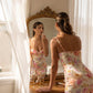 Roselle floral satin slip dress in cream with vintage rose print, showing back detail and corset bust reflection in a vintage mirror.