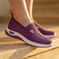 Amethyst purple Ruxen slip-on sneakers worn by a person on sunlit stone steps, showcasing the breathable woven knit upper with diamond perforations and triangular cutout, atop a white platform sole.