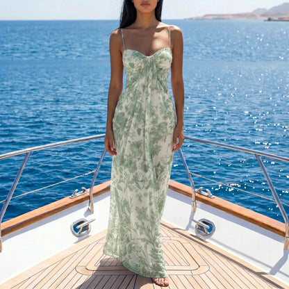 Zenthos Sage Botanical mesh floral maxi dress worn by a model on a yacht, featuring spaghetti straps and a gathered sweetheart bodice.