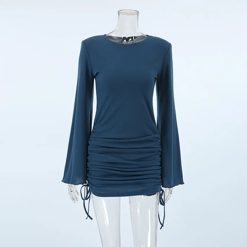 Fitted ribbed knit mini dress in deep sapphire blue, featuring a crew neck, dramatic long bell sleeves with a lettuce hem, and adjustable side ruching. Presented on a mannequin from the front.