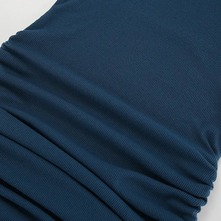 Close-up view of a sapphire blue ribbed knit mini dress, showcasing its fine vertical ribbing texture and adjustable side ruching detail with drawstring ties.