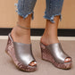 Silver-grey peep-toe wedge mule sandals with a textured rose gold and brown wedge heel, worn by a model with distressed denim jeans and an anklet. This variant showcases the elegant platform sandal in a neutral setting.