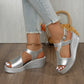 Silver metallic peep-toe wedge sandals with an embossed crocodile texture, worn by a model with distressed denim jeans featuring frayed hems, showcased on a wooden floor.