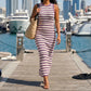 Zyphron sleeveless ribbed knit maxi dress in dusty mauve and off-white stripes, worn by model walking on a marina pier. Bodycon fit, high crew neck, and horizontal pattern.