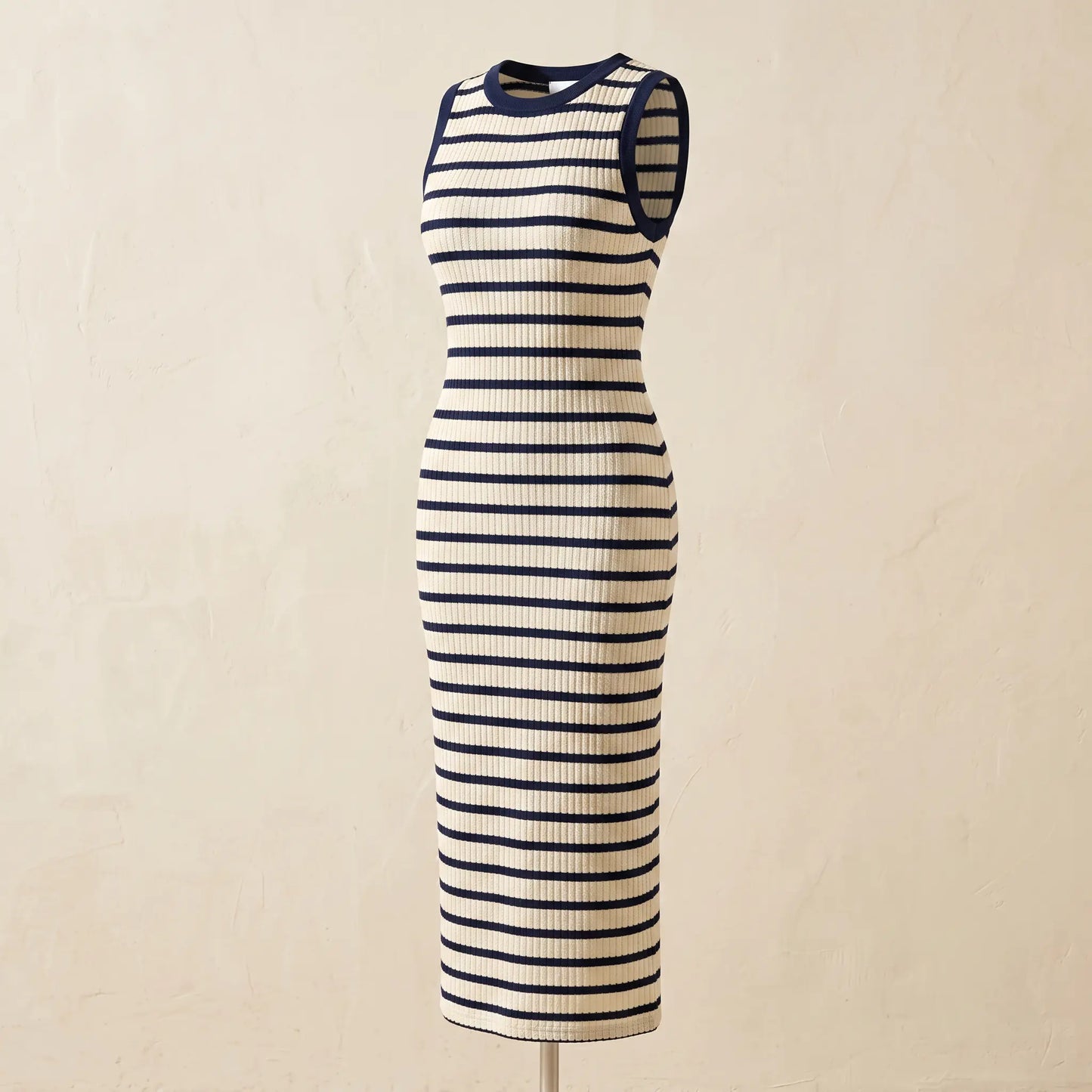 Sleeveless ribbed knit maxi dress with cream and navy horizontal stripes, featuring a classic crew neckline and solid armhole binding, on a mannequin.
