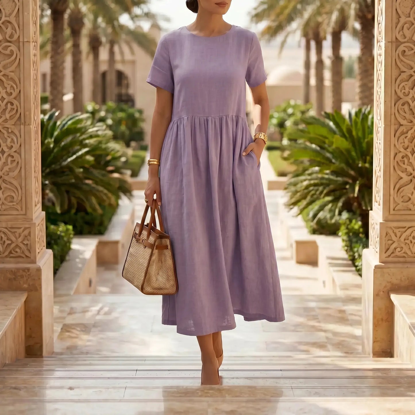 Elegant woman wearing a flowy Soft Lilac linen-blend midi dress with short sleeves and gathered empire waist, walking outdoors.